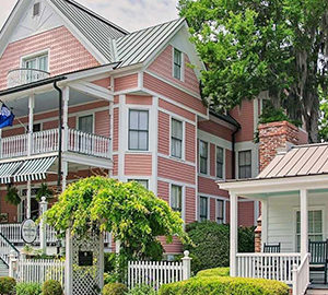 Treat Mom to the Beaufort Inn. Pink house with wrap-around porch