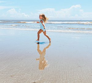 Fripp Island Golf & Beach Resort. a little girl running on a beach