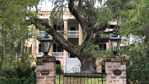 Historic Beaufort’s Architectural Gems. a large house with columns and two story porch